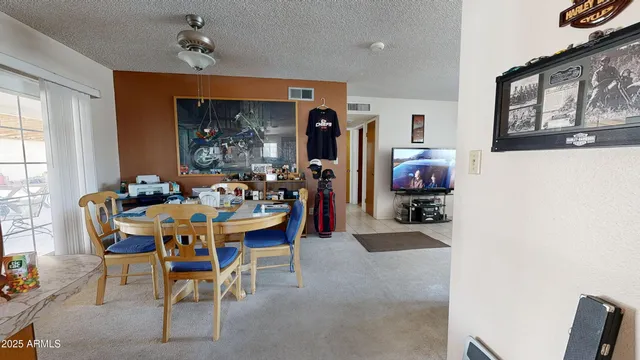 a view of a dining room with furniture and a window