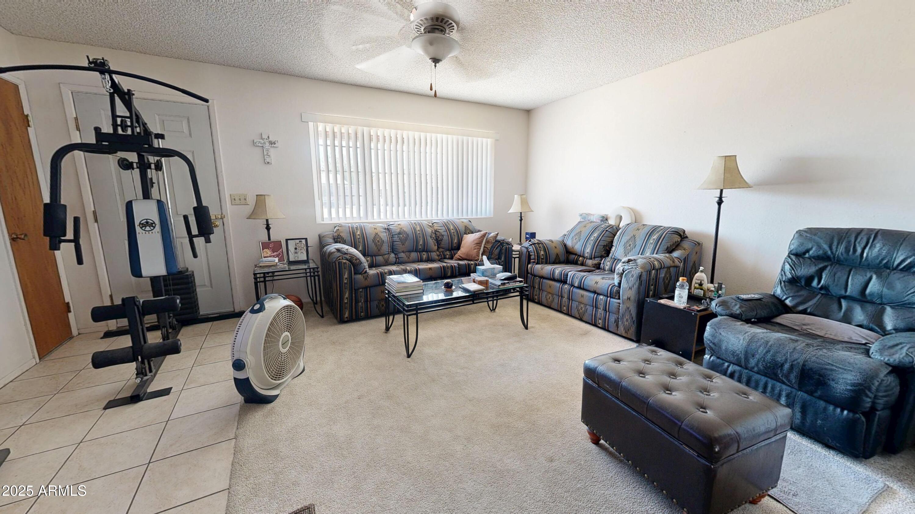 1432 South Lawther Drive Apache Junction, AZ 85120 - Photo 7 of 29 a living room with furniture a window and gym equipment