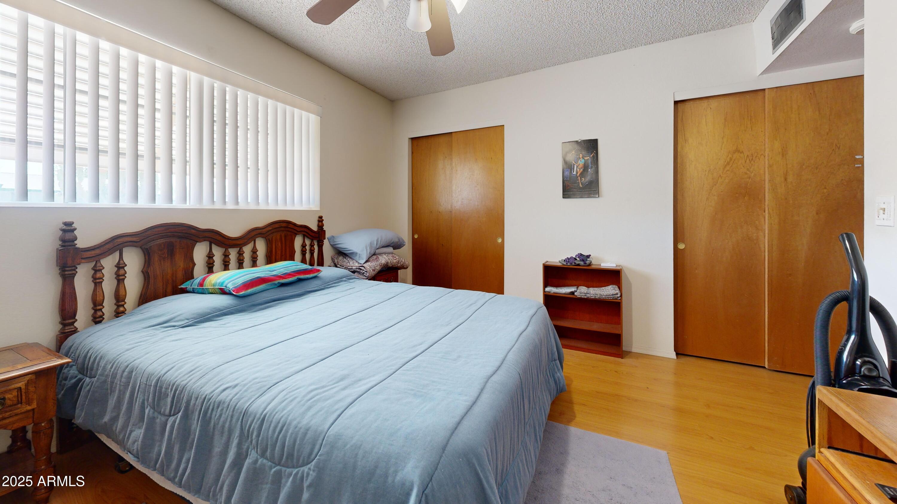 1432 South Lawther Drive Apache Junction, AZ 85120 - Photo 10 of 29 a bedroom with a bed and a flat tv screen on dresser