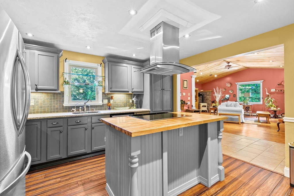 150 Ryder Road Rochester, MA 02770 - Photo 13 of 42 a kitchen with stainless steel appliances a sink stove and wooden floor