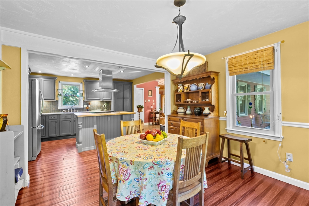 150 Ryder Road Rochester, MA 02770 - Photo 14 of 42 a view of a dining room and livingroom with furniture wooden floor a chandelier