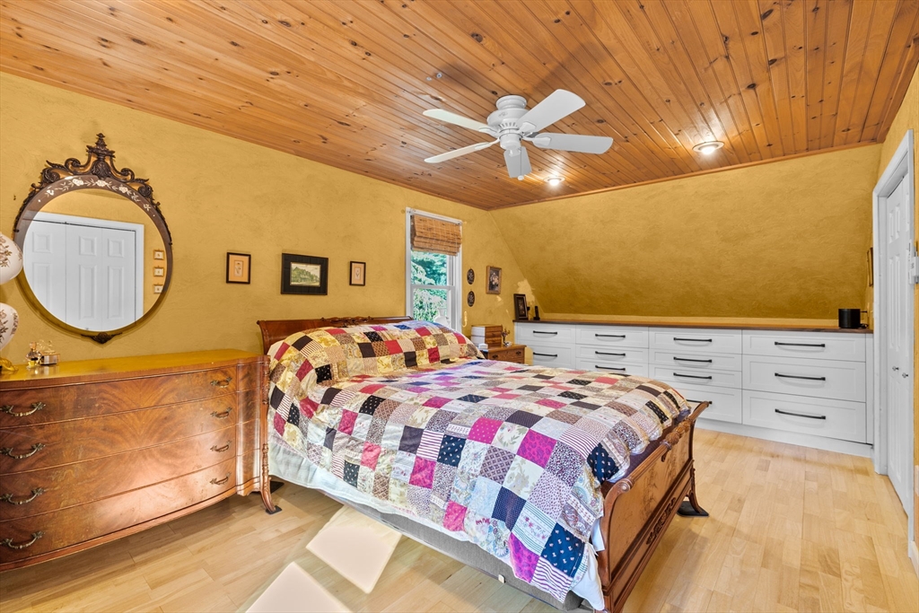 150 Ryder Road Rochester, MA 02770 - Photo 21 of 42 a bedroom with a bed and a chandelier