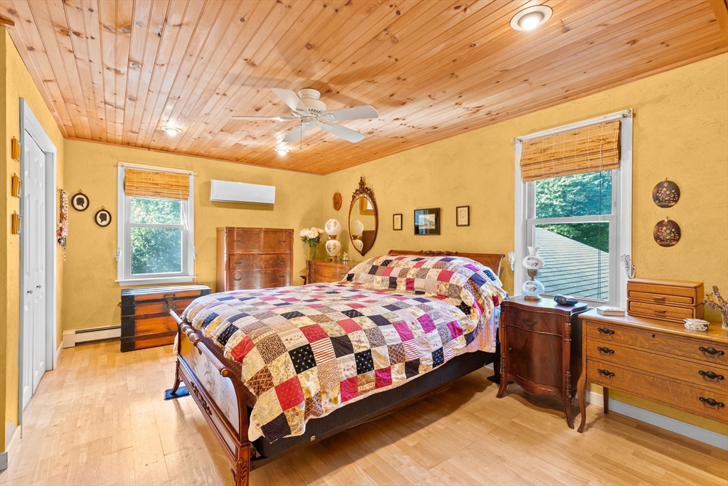 150 Ryder Road Rochester, MA 02770 - Photo 22 of 42 a bedroom with a bed and large windows