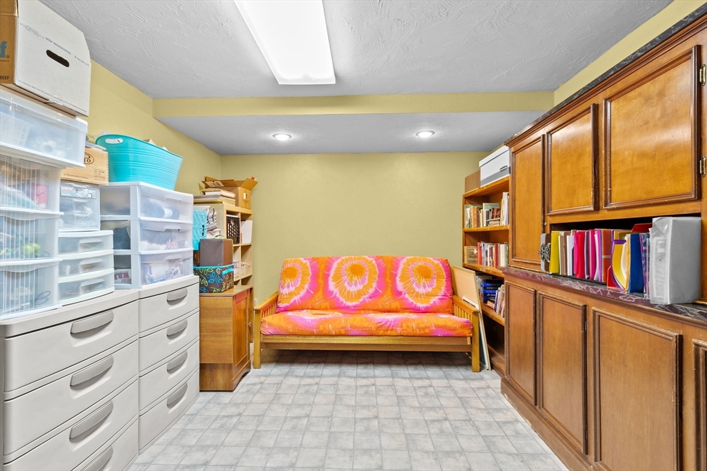 150 Ryder Road Rochester, MA 02770 - Photo 24 of 42 a yellow room with lots of books on the wall