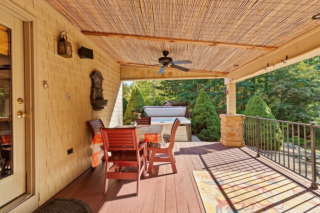 150 Ryder Road Rochester, MA 02770 - Photo 29 of 42 a view of a patio with table and chairs with wooden floor and fence