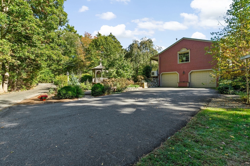 150 Ryder Road Rochester, MA 02770 - Photo 35 of 42 a front view of a house with a yard and garage