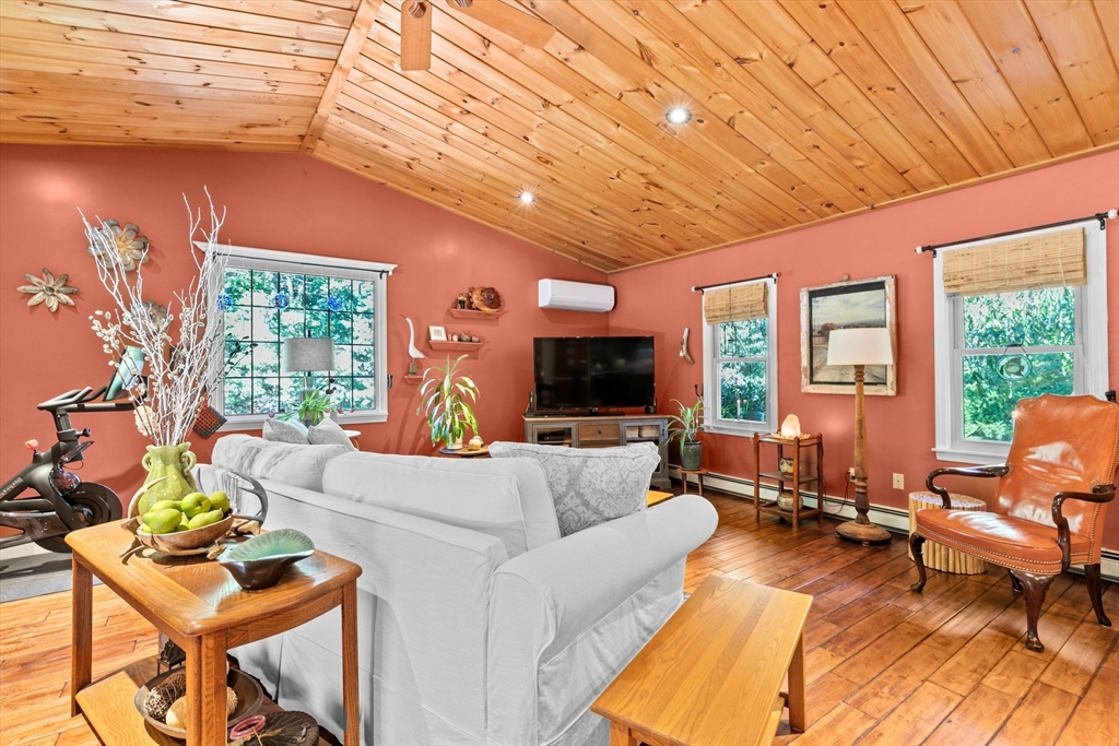 150 Ryder Road Rochester, MA 02770 - Photo 4 of 42 a living room with furniture a flat screen tv and a large window