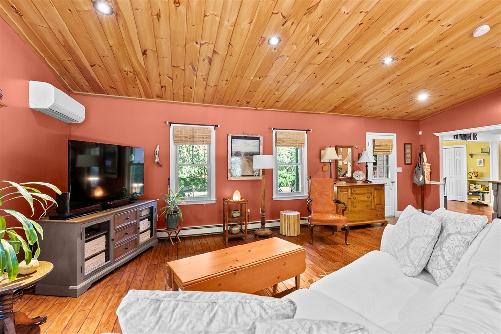 150 Ryder Road Rochester, MA 02770 - Photo 6 of 42 a living room with furniture a flat screen tv and floor to ceiling window