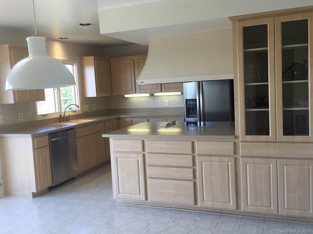 156 Luther Durham Road Tryon, NC 28782 - Photo 12 of 23 a kitchen with cabinets and stainless steel appliances