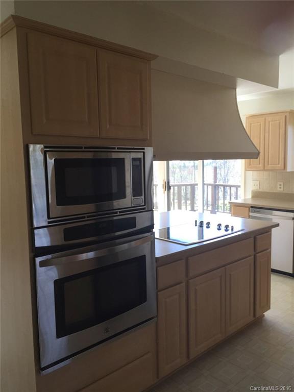 156 Luther Durham Road Tryon, NC 28782 - Photo 14 of 23 a kitchen with stainless steel appliances a stove microwave and cabinets