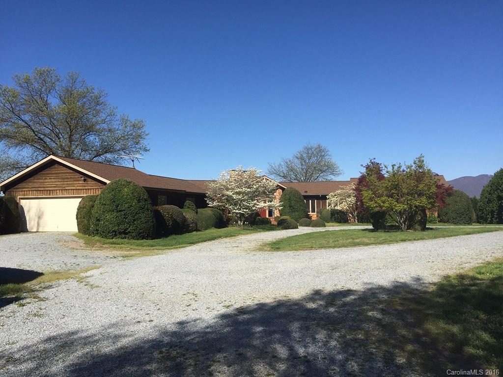 156 Luther Durham Road Tryon, NC 28782 - Photo 23 of 23 a front view of a house with a yard and garage