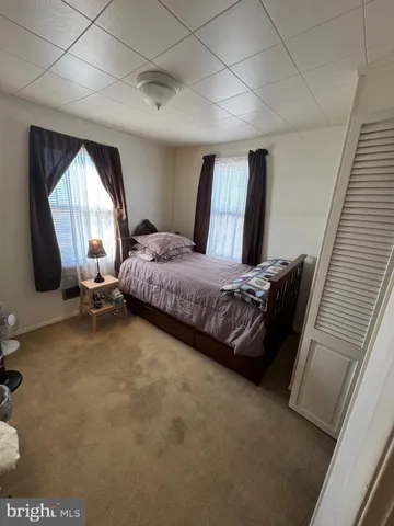 a bed room with a bed and a large window