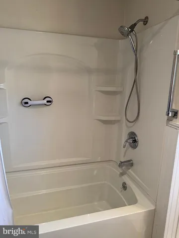 a bathroom with a bath tub with a shower