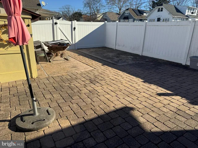 a view of a backyard with table and chairs