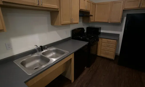 a kitchen with a sink stove and cabinets