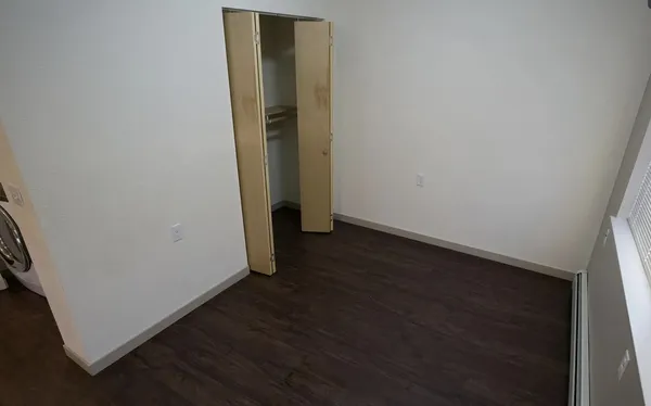 an empty room with wooden floor