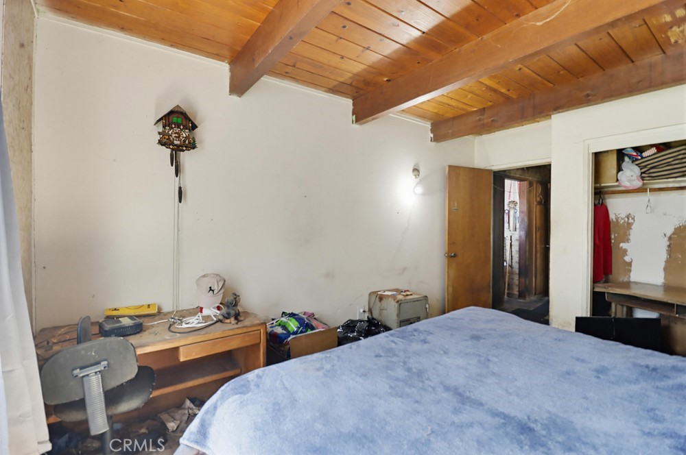 736 Sacramento Avenue Spring Valley, CA 91977 - Photo 16 of 33 a bedroom with bed and a chandelier
