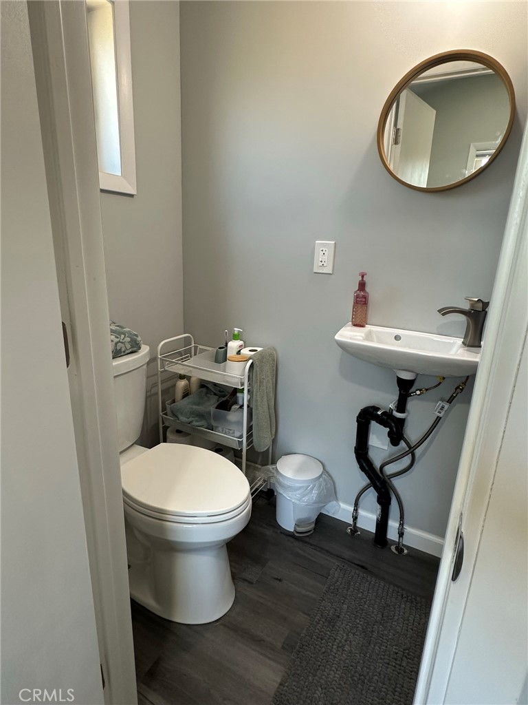 626 Broadway Gilroy, CA 95020 - Photo 4 of 5 a bathroom with a toilet a sink and a mirror