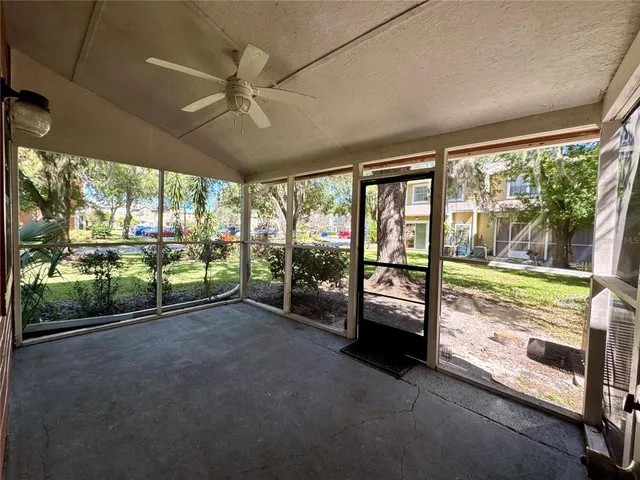 a view of a porch with furniture and floor to ceiling window
