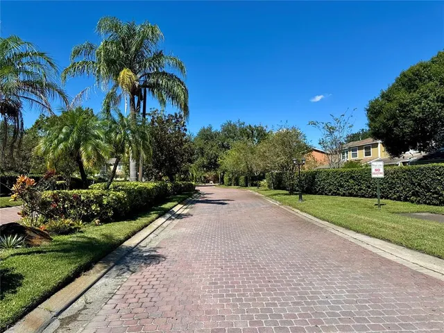 a view of a garden with a building in the background