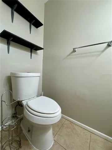 a white toilet sitting next to a shower