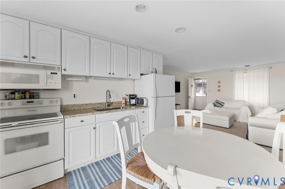 63 Bayview Lane Hague, VA 22469 - Photo 14 of 23 a living room with white cabinets and white appliances