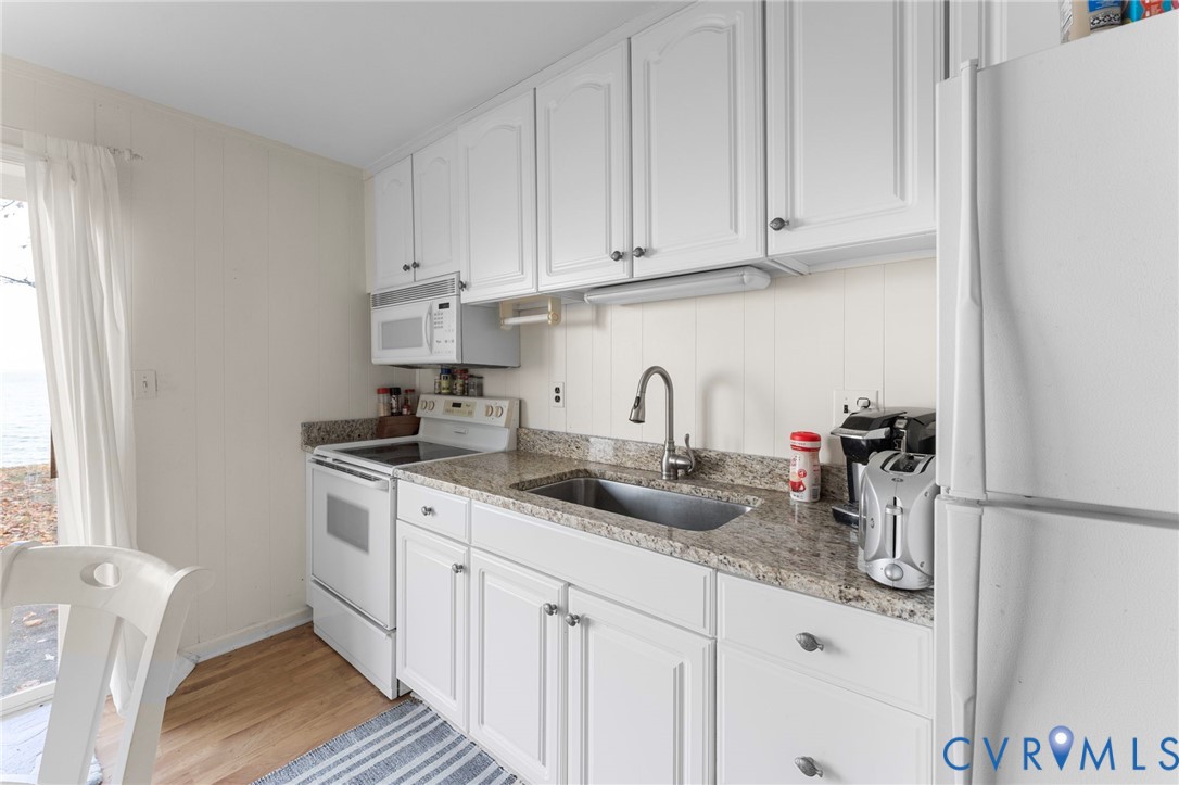 63 Bayview Lane Hague, VA 22469 - Photo 16 of 23 a kitchen with stainless steel appliances granite countertop a sink and a white cabinets