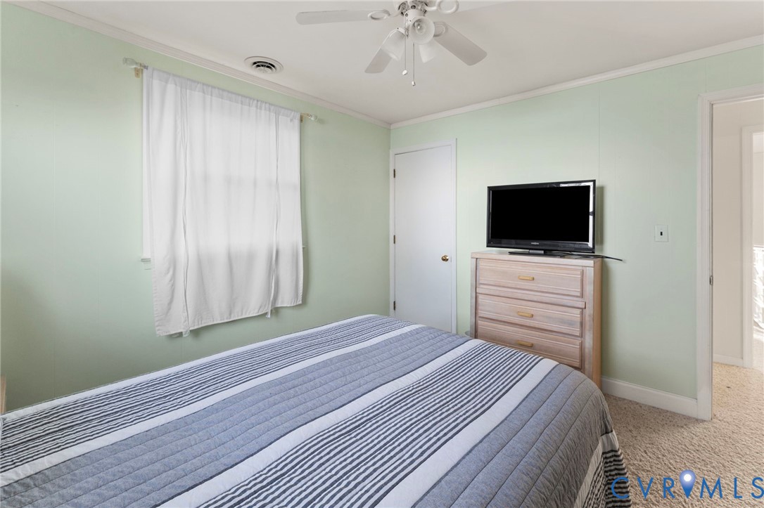 63 Bayview Lane Hague, VA 22469 - Photo 22 of 23 a bedroom with a bed and a flat screen tv