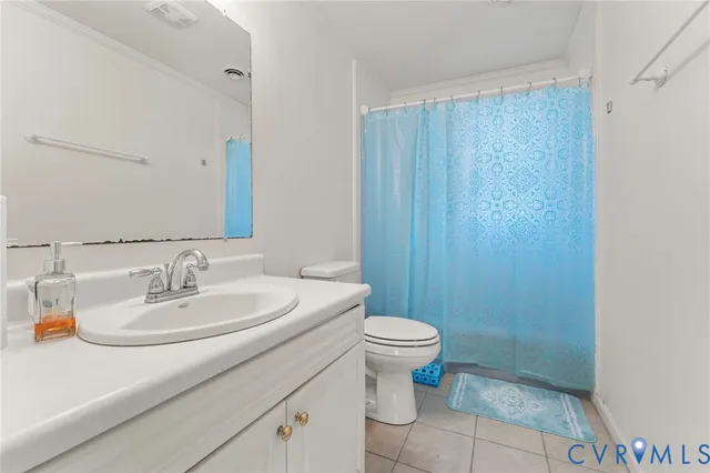 a bathroom with a sink a toilet a mirror and shower