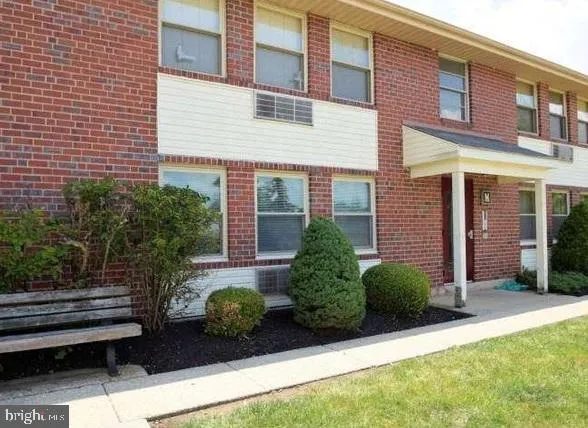 a view of a house with a garden and plants