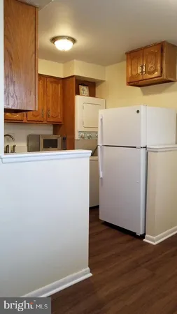 a white refrigerator freezer sitting inside of a kitchen