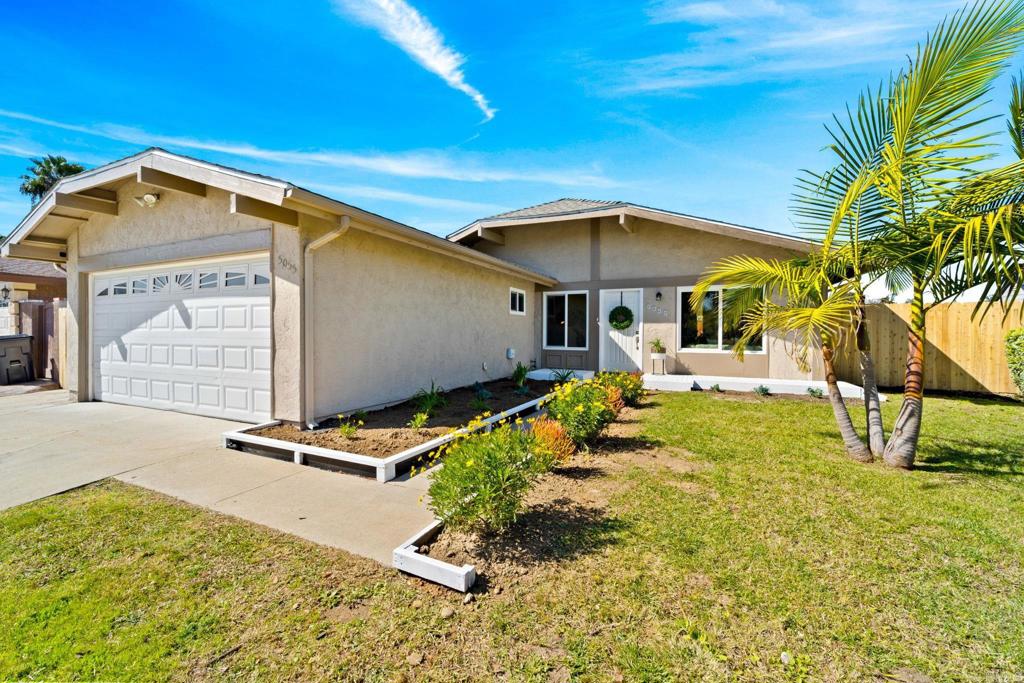 a backyard of a house with table and chairs