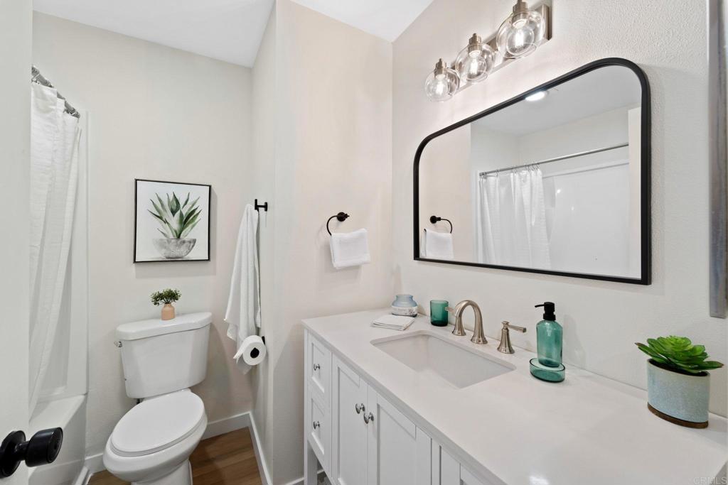 5055 Andrew Jackson Street Oceanside, CA 92057 - Photo 23 of 43 a bathroom with a toilet a sink and mirror