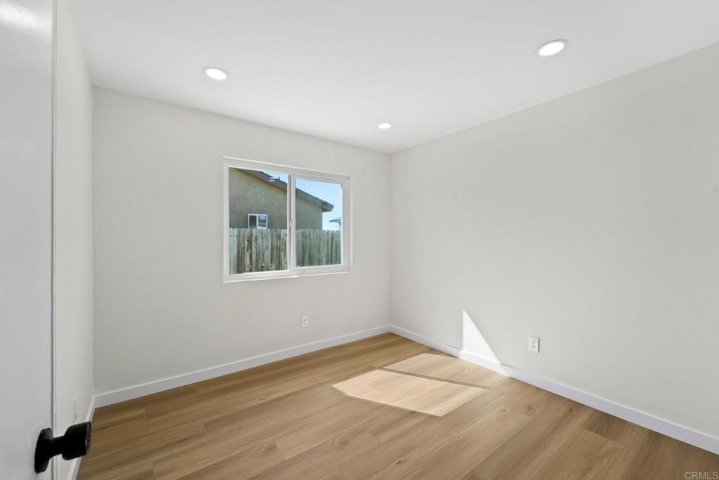 5055 Andrew Jackson Street Oceanside, CA 92057 - Photo 25 of 43 an empty room with wooden floor and windows