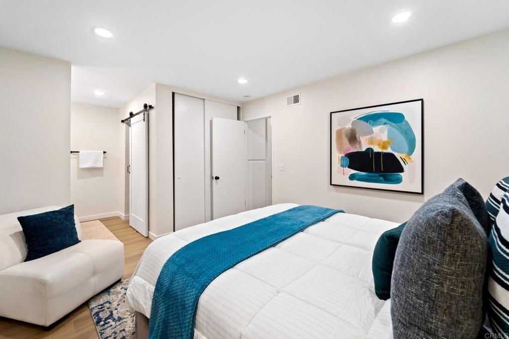 5055 Andrew Jackson Street Oceanside, CA 92057 - Photo 28 of 43 a bedroom with a bed and a painting on the wall