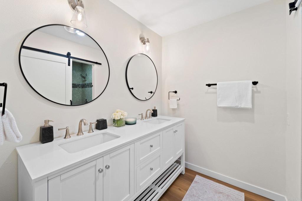 5055 Andrew Jackson Street Oceanside, CA 92057 - Photo 29 of 43 a bathroom with a double vanity sink and a mirror