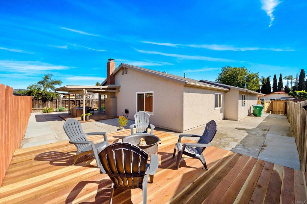 5055 Andrew Jackson Street Oceanside, CA 92057 - Photo 35 of 43 a view of a patio with table and chairs with wooden floor