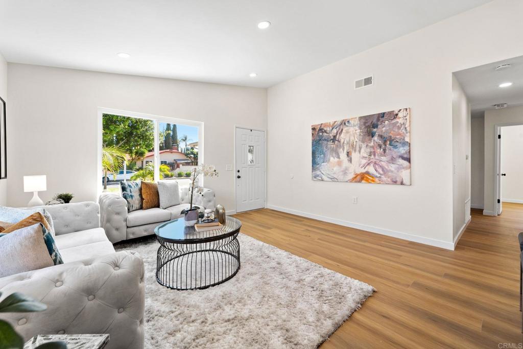 5055 Andrew Jackson Street Oceanside, CA 92057 - Photo 4 of 43 a living room with furniture potted plant and a wooden floor