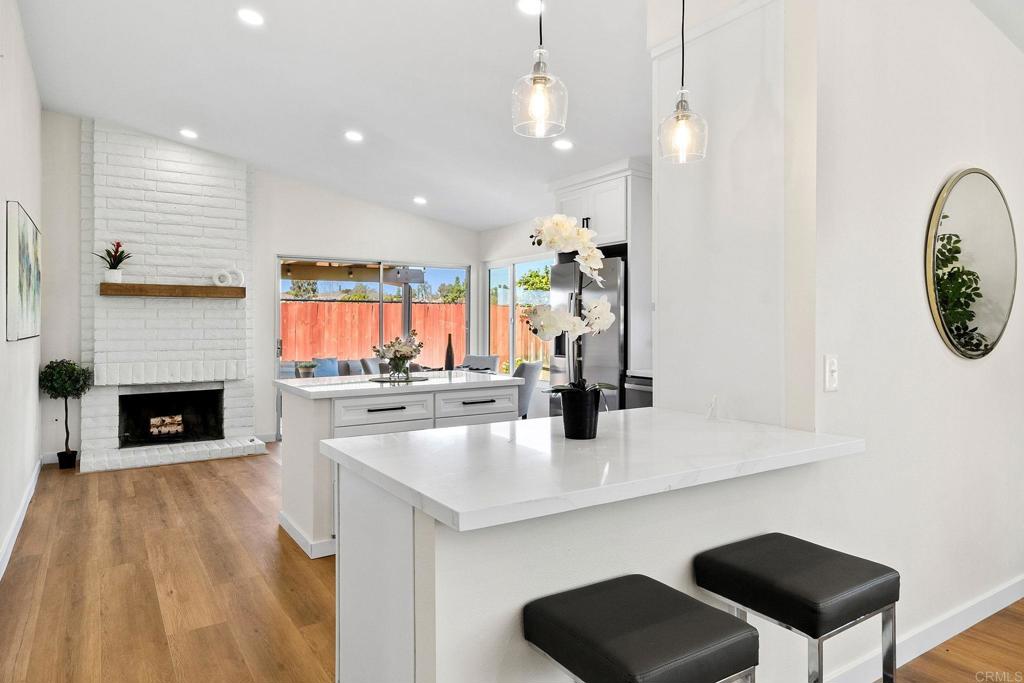 5055 Andrew Jackson Street Oceanside, CA 92057 - Photo 7 of 43 a open kitchen with a sink a fireplace and chairs