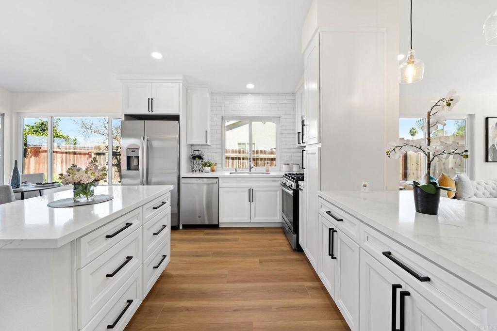 5055 Andrew Jackson Street Oceanside, CA 92057 - Photo 8 of 43 a large kitchen with stainless steel appliances lots of counter space and a sink