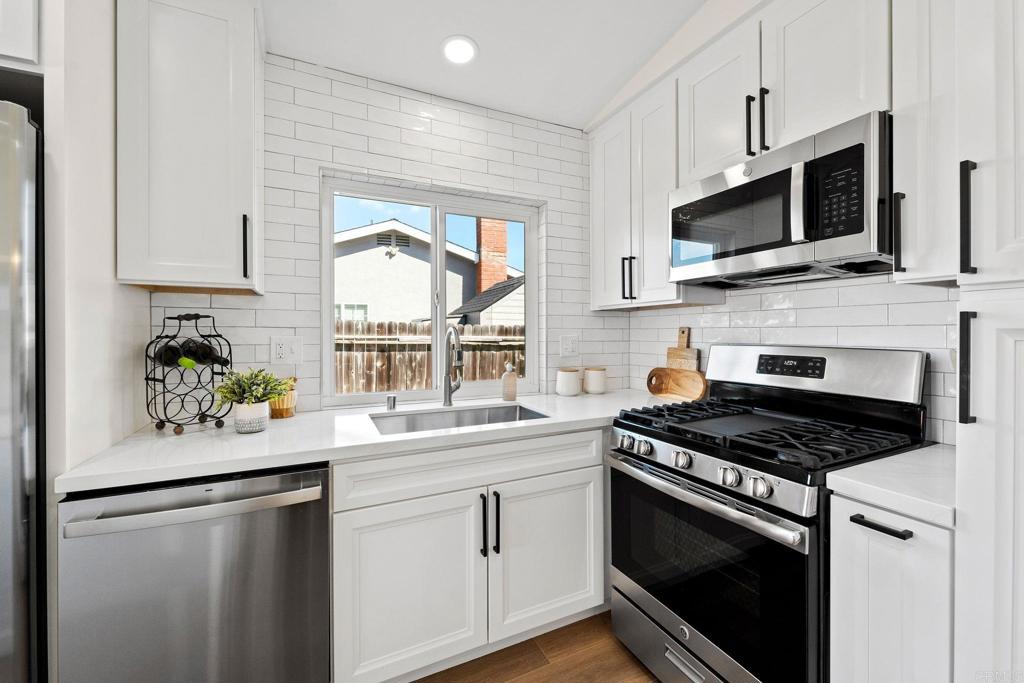 5055 Andrew Jackson Street Oceanside, CA 92057 - Photo 10 of 43 a kitchen with stainless steel appliances a stove microwave and sink
