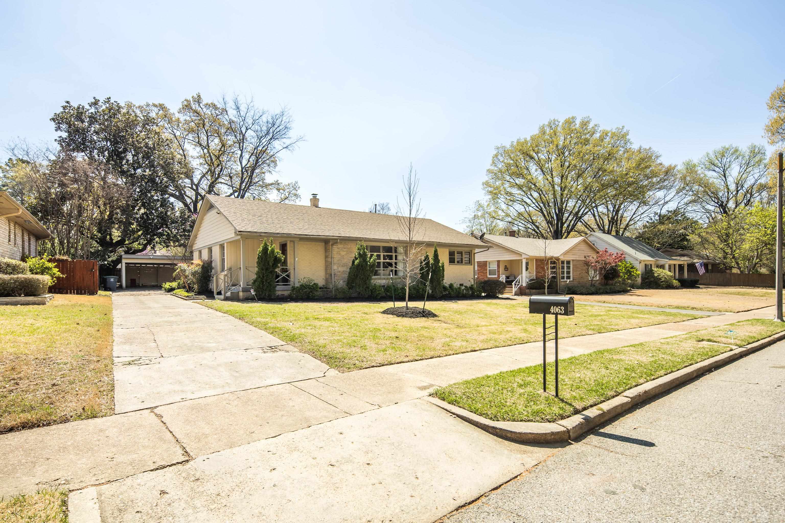 4063 Minden Road Memphis, TN 38117 - Photo 2 of 35 a swimming pool with some tall trees