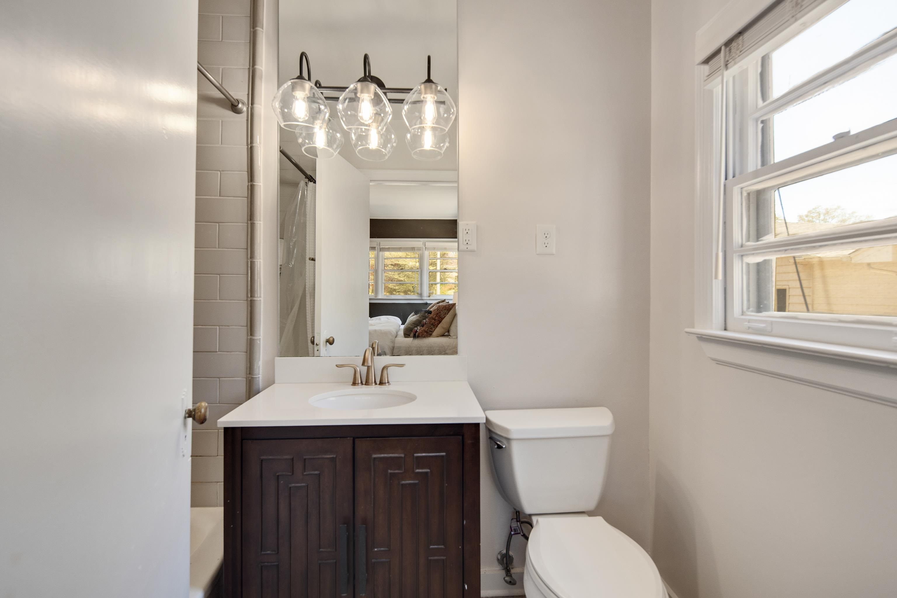 4063 Minden Road Memphis, TN 38117 - Photo 21 of 35 a bathroom with a sink a toilet and mirror