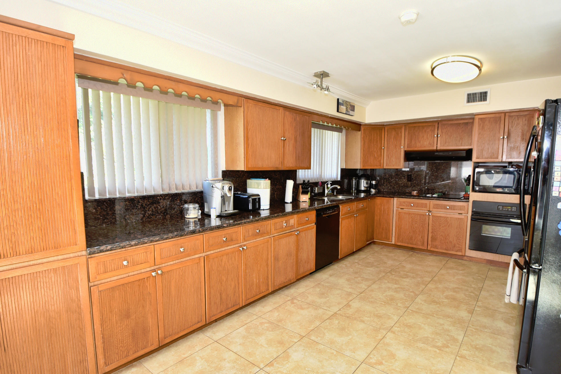 400 Northeast 2nd Street Boca Raton, FL 33432 - Photo 14 of 40 a kitchen with stainless steel appliances granite countertop a stove a sink and a microwave