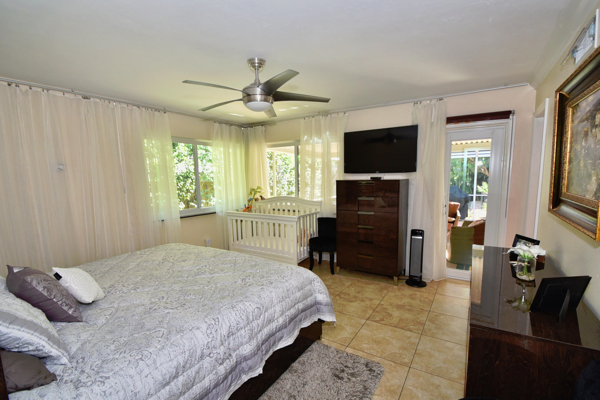 400 Northeast 2nd Street Boca Raton, FL 33432 - Photo 17 of 40 a bedroom with a bed and a flat screen tv