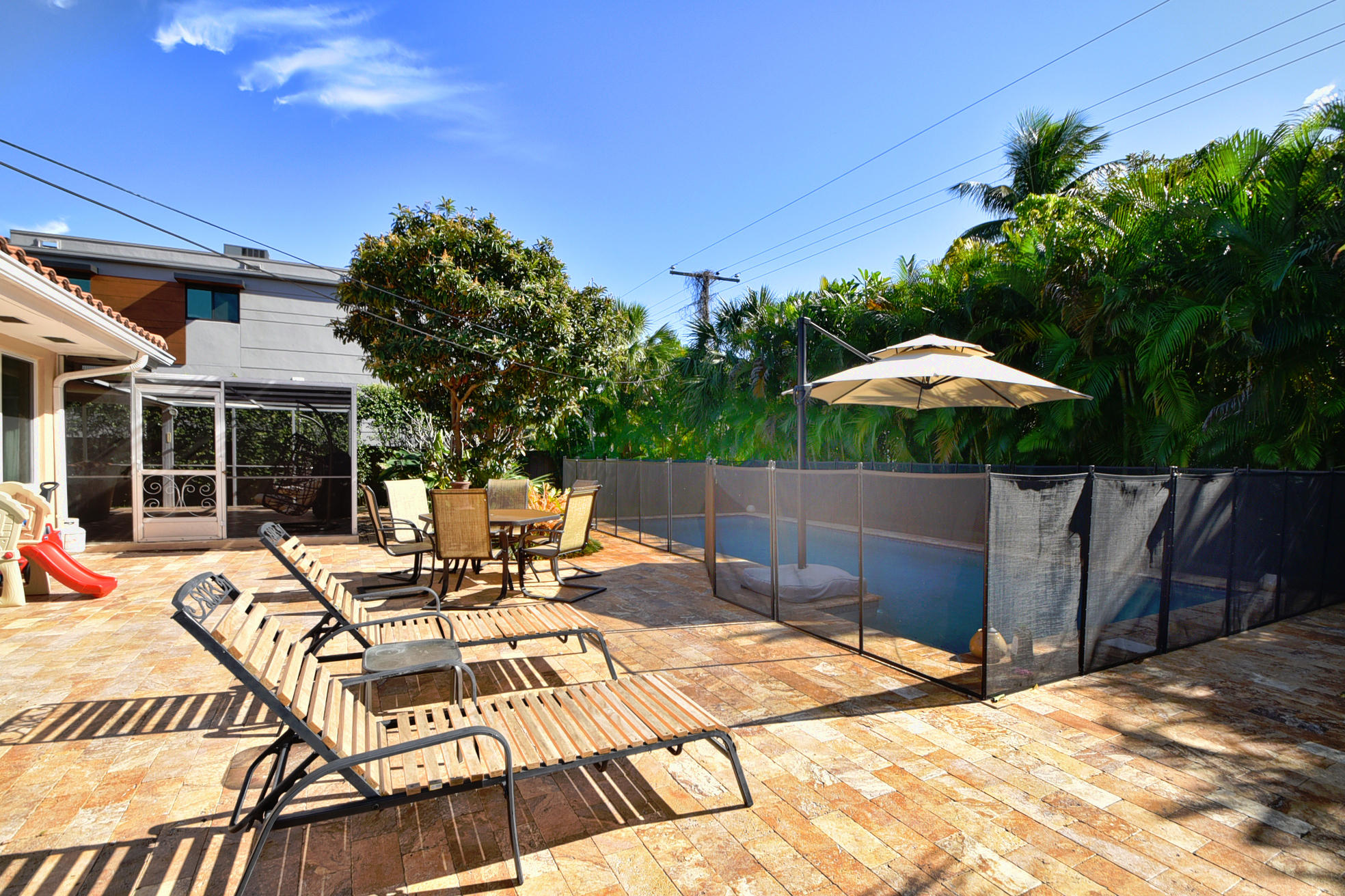 400 Northeast 2nd Street Boca Raton, FL 33432 - Photo 26 of 40 a view of a patio with a table and chairs under an umbrella