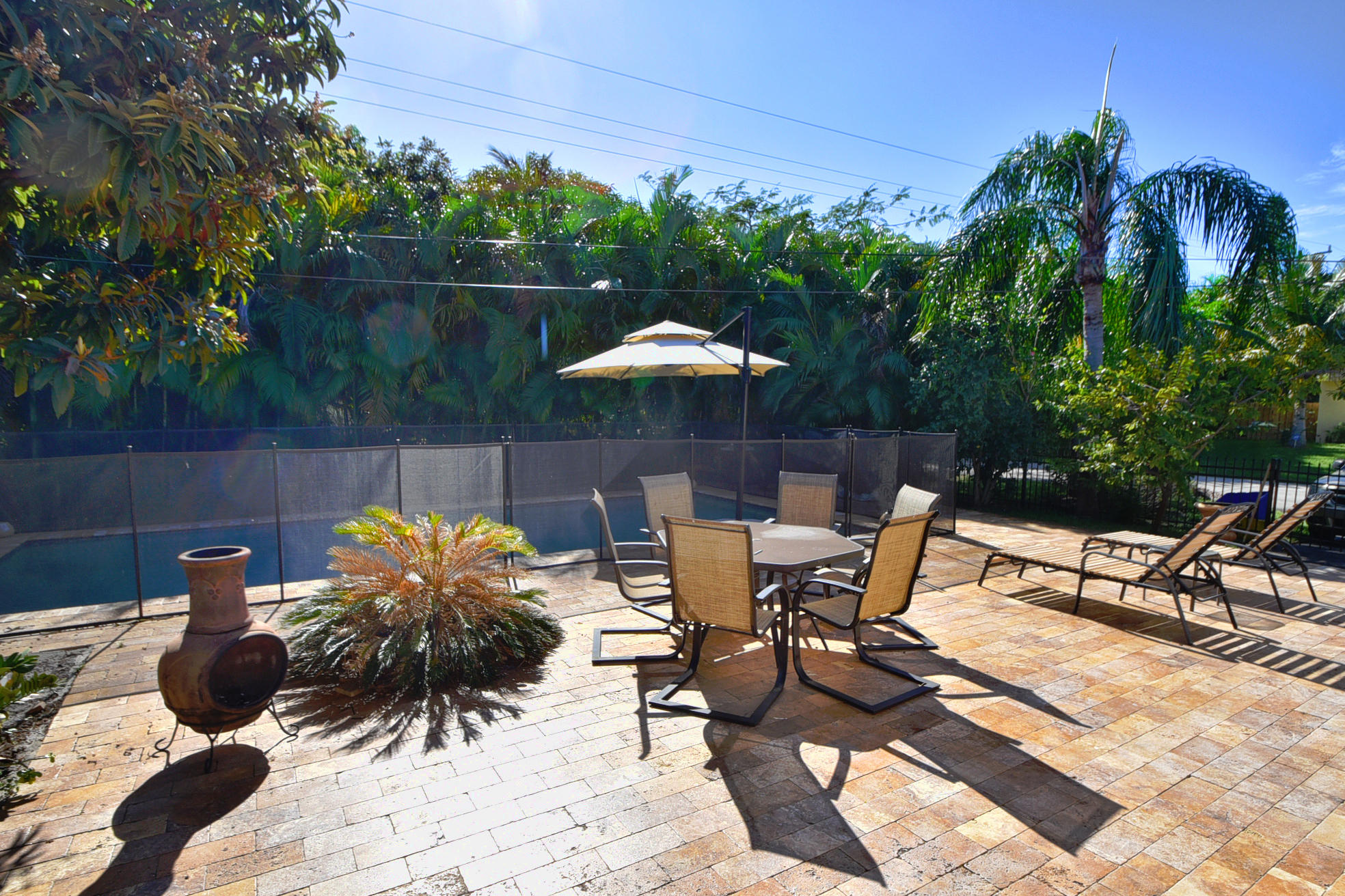 400 Northeast 2nd Street Boca Raton, FL 33432 - Photo 30 of 40 a view of backyard with seating space and trees