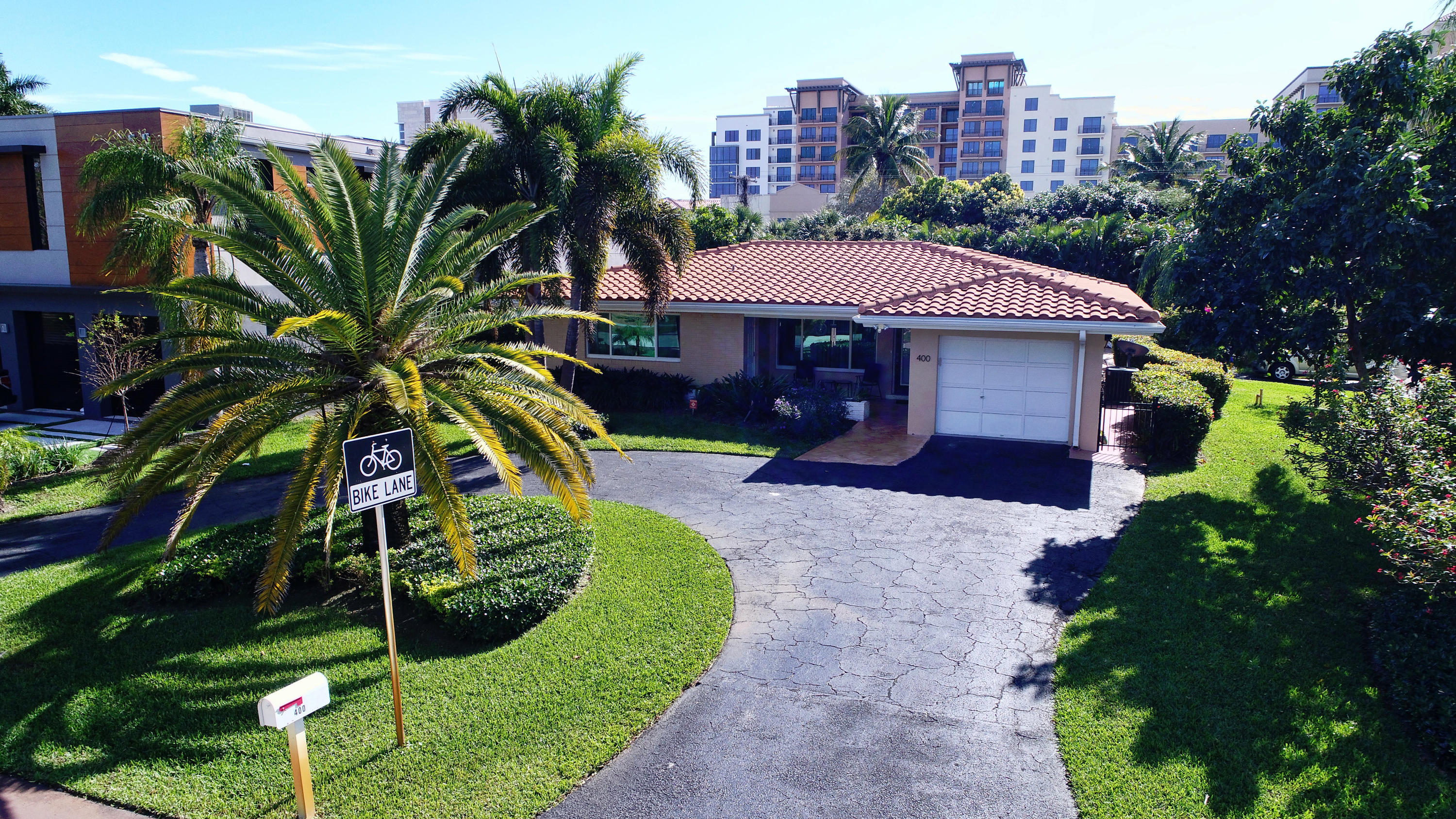 400 Northeast 2nd Street Boca Raton, FL 33432 - Photo 31 of 40 a front view of a house with a yard and potted plants