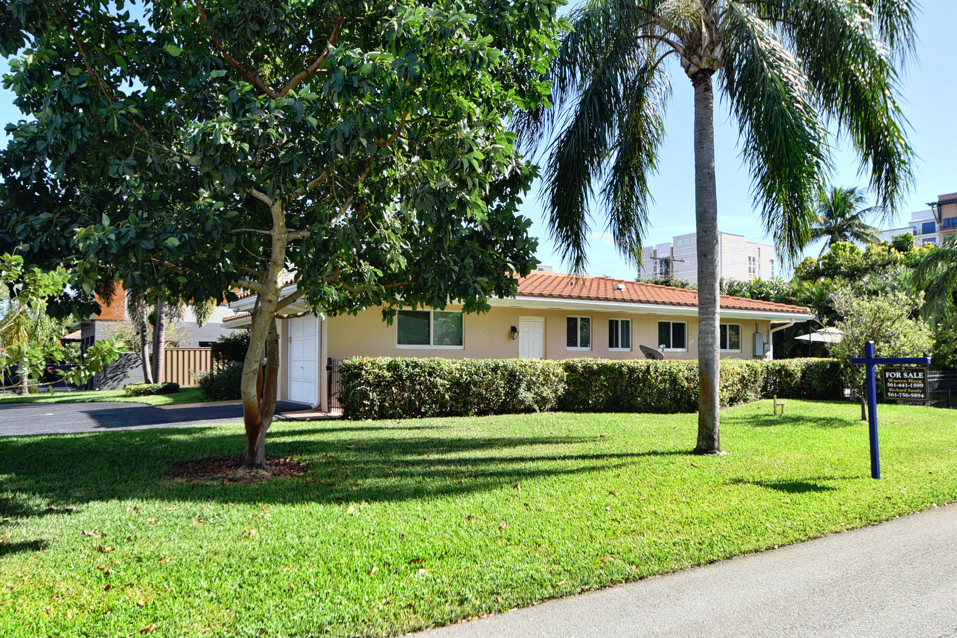 400 Northeast 2nd Street Boca Raton, FL 33432 - Photo 5 of 40 a front view of a house with a yard