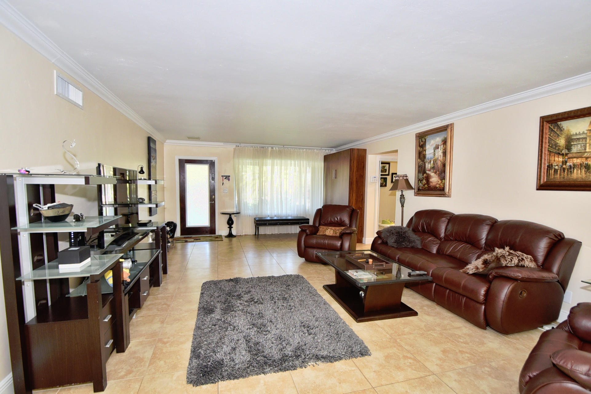 400 Northeast 2nd Street Boca Raton, FL 33432 - Photo 6 of 40 a living room with furniture a rug kitchen view and a window